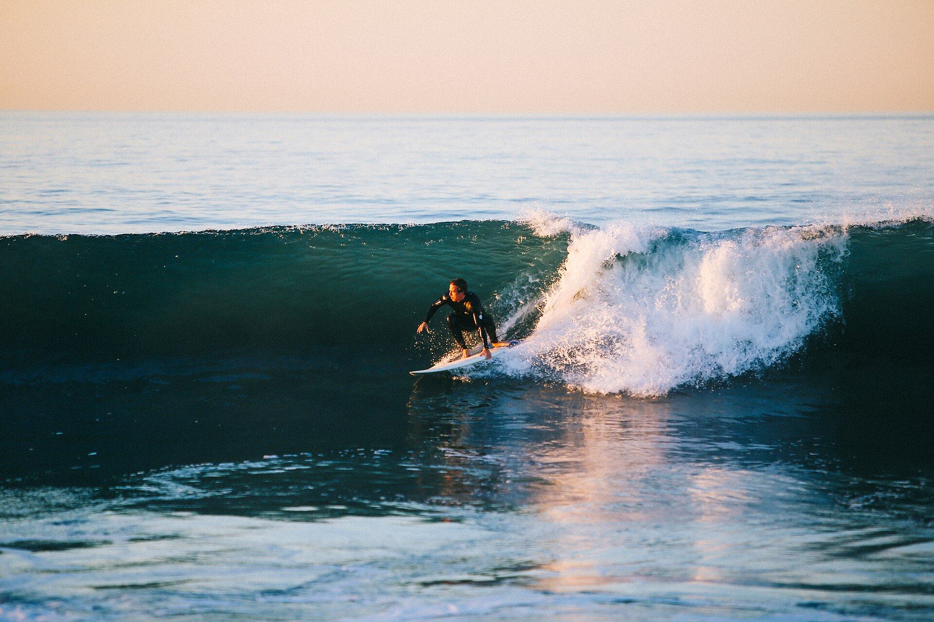 A surfer riding a clean ocean wave.